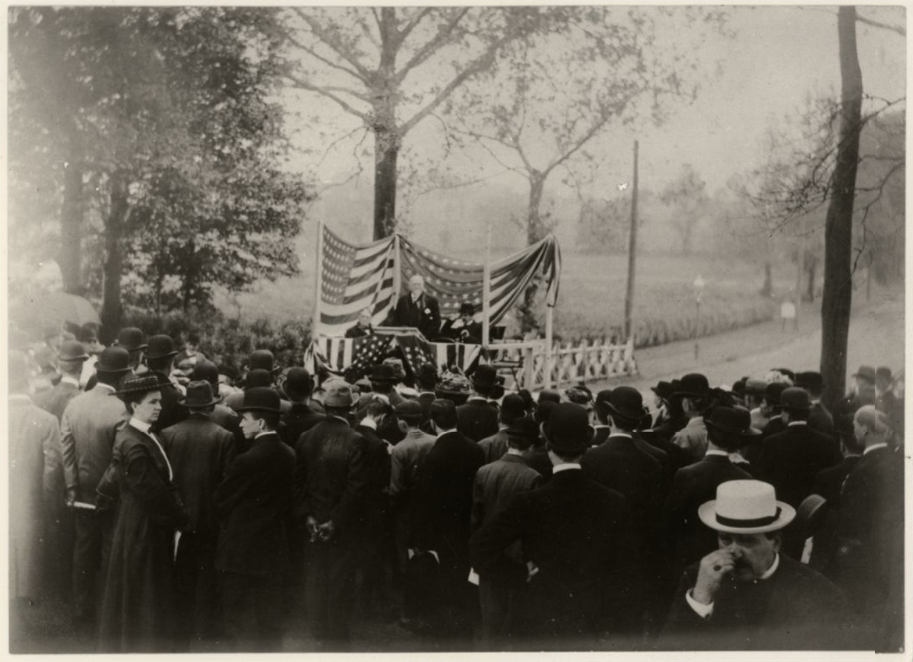 Reverend Slicer speaks from a flag-festooned outdoor podium, facing a standing audience at the celebration of the one hundredth anniversary of the death of Thomas Paine at the Paine monument in New Rochelle on June 5th, 1909. Profesor Thaddeus B. Wakeman, president, Thomas Paine Historical Association, presided. William van der Weyde, who would later serves as President of the Thomas Paine National Historical Association from 1920 to 1929, possibly took this photograph. Slicer, of All Souls' Unitarian Church, N. Y, gave an address entitled, "Thomas Paine as the Devotee of Liberty" - American Philosophical Society