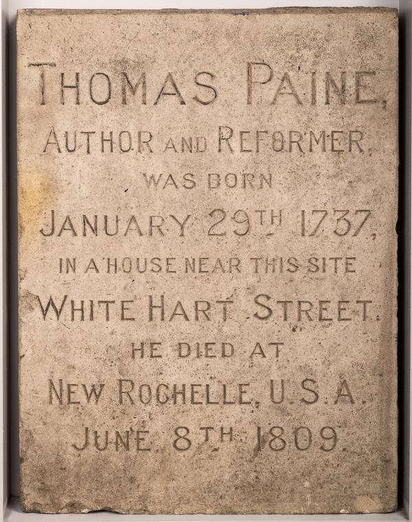 A commemorative stone in Thetford, England made of a rectangular block of limestone with an incised inscription: "Thomas Paine / author and reformer / was born / January 29th 1737 / in a house near this site / White Hart Street / He died at / New Rochelle USA / June 8th 1809" - Ancient House Museum
