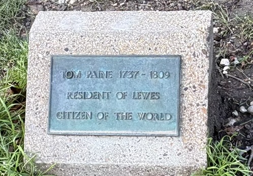 A plaque in Lewes, UK sits in the ground between Castle Gate and Castle Banks. It reads in part, "Resident of Lewes, Citizen of the World".